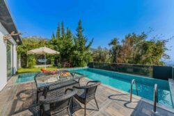 white home has a luxurious backyard