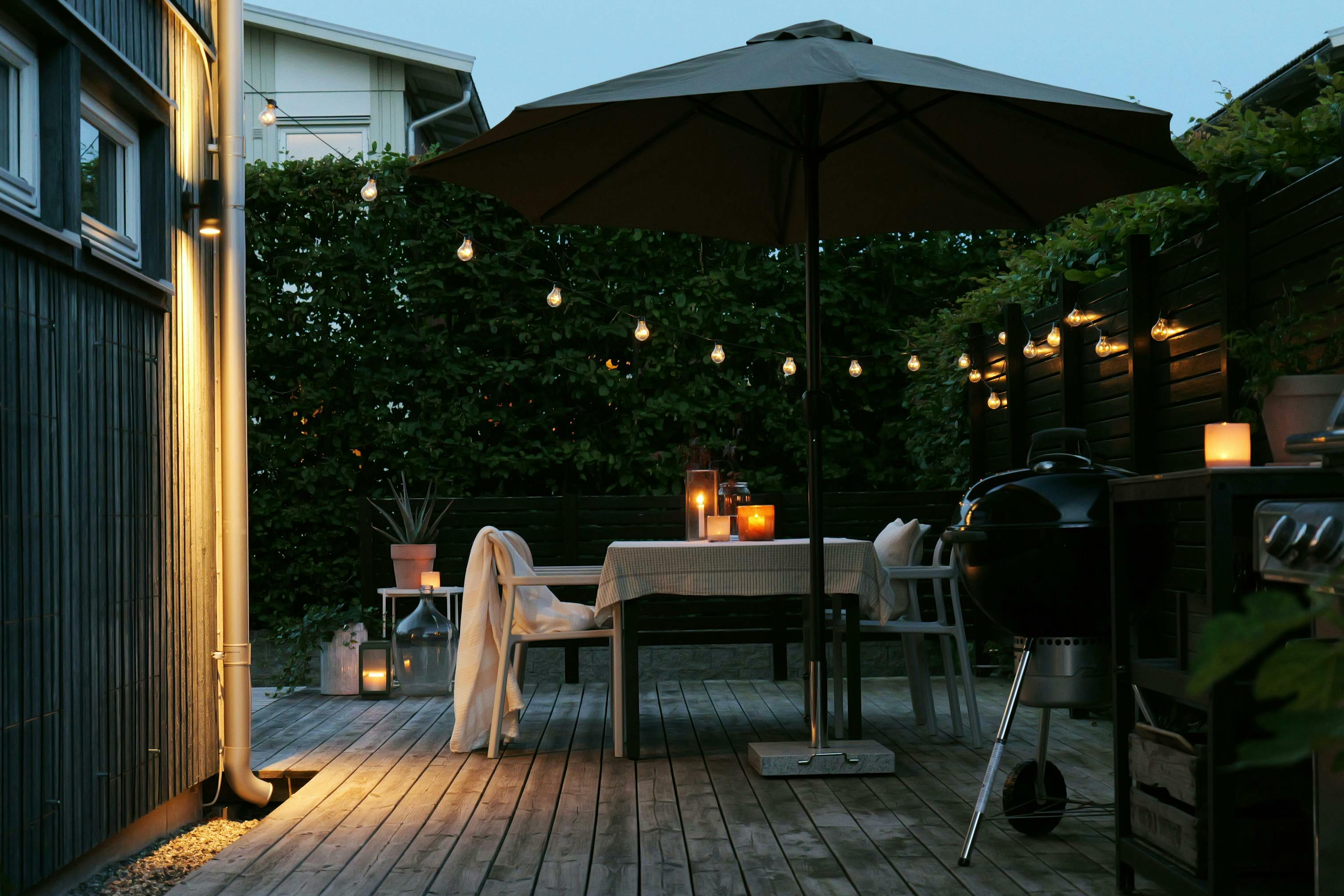 An outdoor space features metal furniture and solar-powered lights for an easy, durable and cozy design.