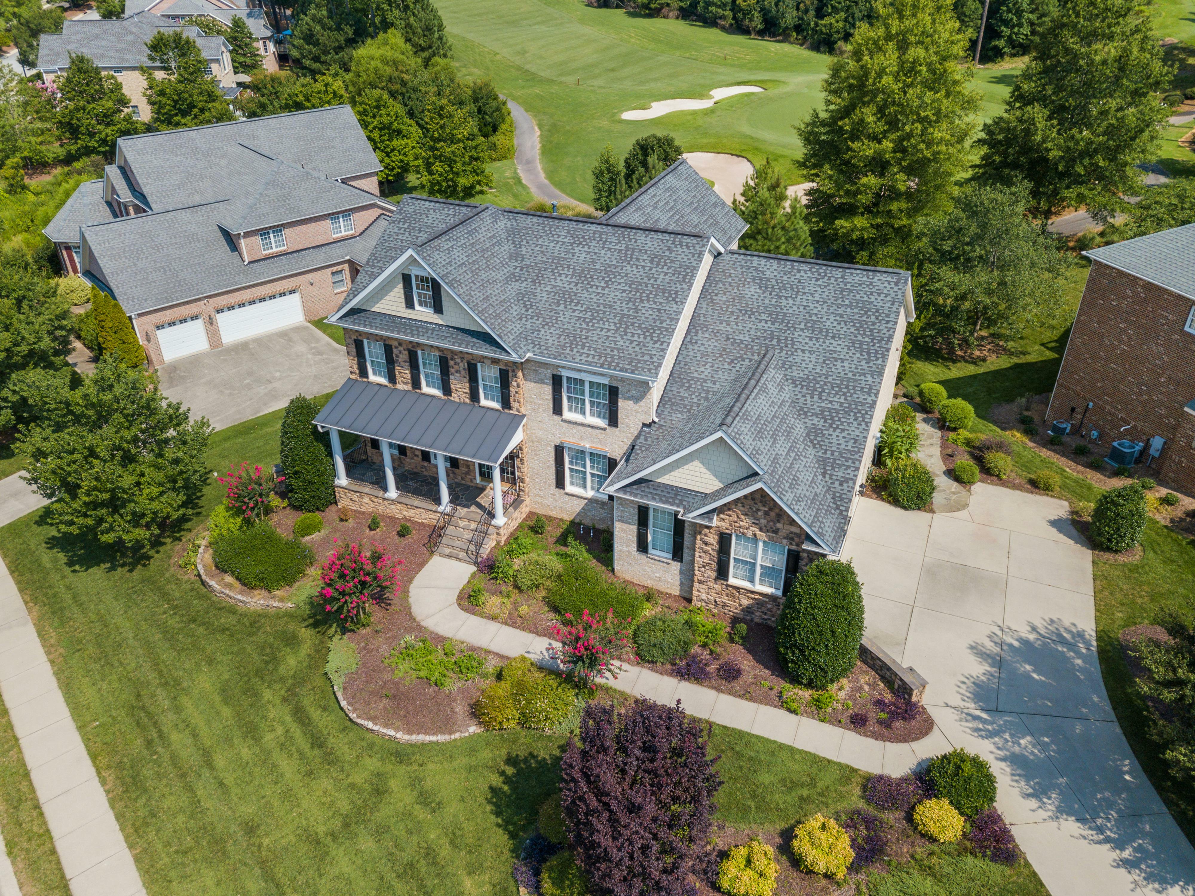 A house has various landscaping and hardscaping zones for a stunning design.